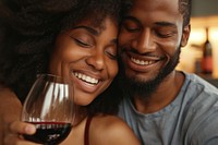 Happy black couple celebrating drink embracing drinking.