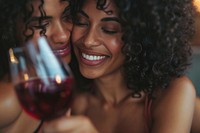 Happy black woman couple celebrating drinking laughing portrait.