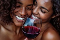 Happy black woman couple celebrating drink embracing drinking.