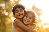Indian sibling kids hugging and laugh laughing person smile.