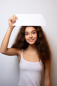Brave teen girl holding up a white paper sign portrait smile photo.