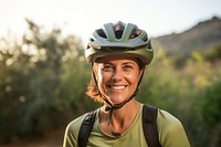 Happy Mexican woman cyclist helmet outdoors smile.