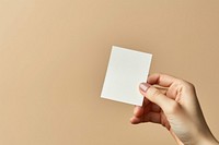 Hand holding blank white sticky note finger paper origami. AI generated Image by rawpixel.