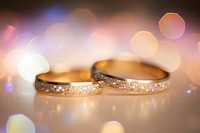 Wedding ring pattern bokeh effect background jewelry gold illuminated.