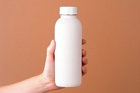 Bottle  holding hand milk.