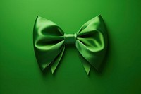 Green bow on empty green background celebration accessories decoration.
