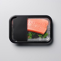 Sealable black plastic tray and cover with salmon and blank label  packaging seafood lunch meal.