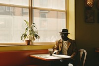 Black man sitting restaurant furniture.