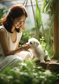 Hong Kong woman playing with a pet portrait outdoors sitting.
