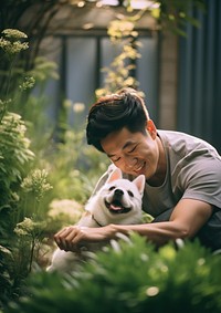 Taiwanese man playing with a pet portrait outdoors mammal.