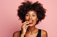 Black woman eating food hamburger biting.
