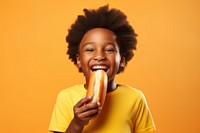 Black little boy eating food biting happiness.
