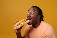 Black man eating food biting hamburger.