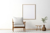 A chair by a woodframe frame  in an empty home furniture cushion canvas.