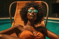  Black women sunbathing poolside glasses. 