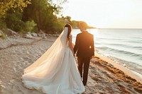 Bride and groom standing wedding tuxedo.