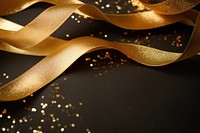 Golden ribbon and glitter paper illuminated backgrounds.