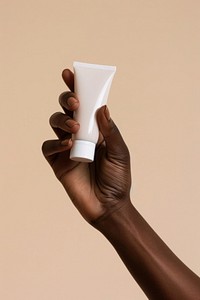 Hand holding cream tube adult simplicity cosmetics.