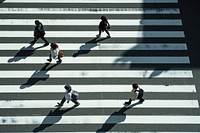 Japanese people walking across the zebra crossing in tokyo adult road infrastructure.