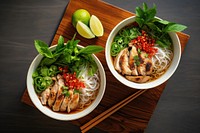 Vietnamese pho noodle bowls soup table food meal.