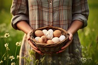 Egg outdoors holding basket.