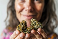 Woman holding cannabis buds finger hand food. 