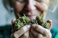 Woman holding cannabis buds finger hand portrait. AI generated Image by rawpixel.