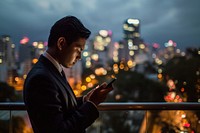 Man in suit looking at his phone city adult photo. AI generated Image by rawpixel.
