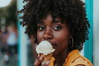 Woman eating ice cream cone dessert food hairstyle.