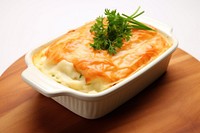 British fish pie in a white ceramic table food vegetable.