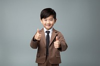 Hongkonger little boy doing thumbs up portrait smile photo.