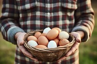 Egg outdoors holding basket.