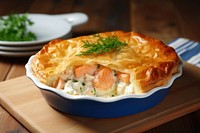 Salmon stuffed pie in a white ceramic pastry dessert table.