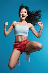 Young Chinese woman full-length model jump smiling sports shorts.