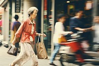 Motion blur old woman walking and carrying shopping bag on street vehicle speed adult.