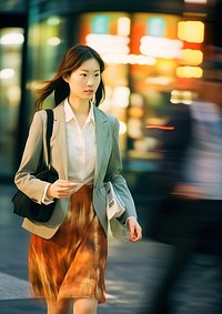 Motion blur businesswoman walking across the street portrait blazer coat.