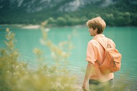 Backpacker on lake shore photography outdoors walking. 