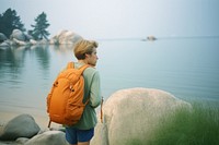 Backpacker on lake shore photography walking adult. 