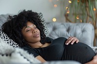 Pregnant woman lying in sofa adult contemplation anticipation. AI generated Image by rawpixel.
