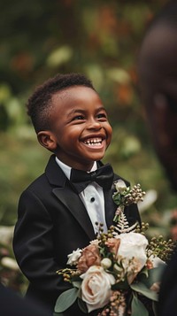 Happy black flower boy wedding portrait bride.