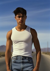 White tank top and jeans poses standing sports barechested.