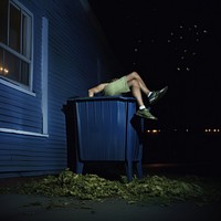 Legs lying on a bin night outdoors adult.