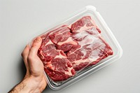 Close-up hand carry choose beef plastic package and cover with blank label meat food pork.