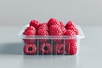 Raspberry in plastic box with cover and blank label food package fruit plant salmonberry.