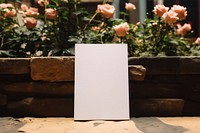 Flatlay blank invitation card  outdoors flower plant.