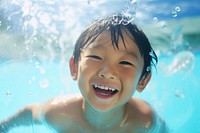 Fun happy asian kid swimming portrait.