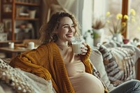 Pregnant british woman smiling sitting drink.