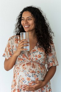 Pregnant latin woman portrait drinking smiling.