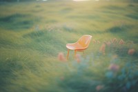  Top view of A simple chair placed in the middle of a grassy field background outdoors nature plant. 