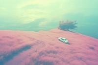  A car parked in the middle of a tall grassy hill outdoors vehicle nature. AI generated Image by rawpixel.